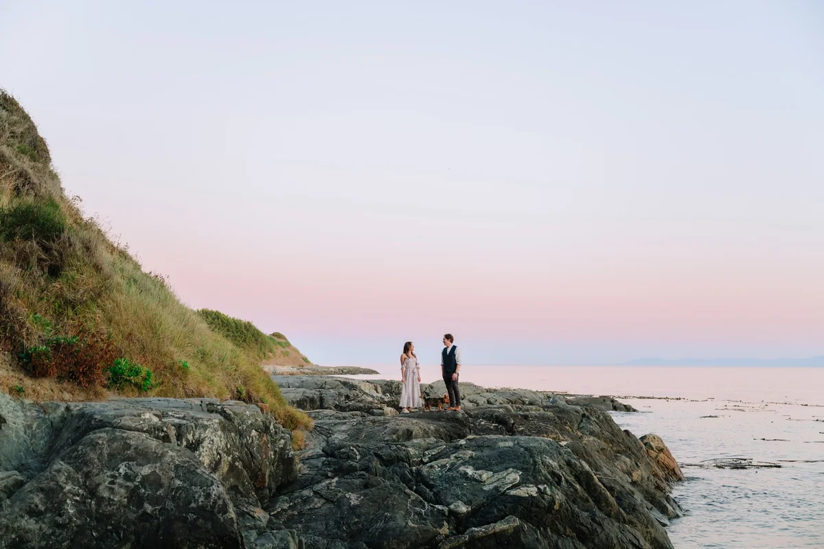 Paulette and Rob together on the rocky shoreline at dusk